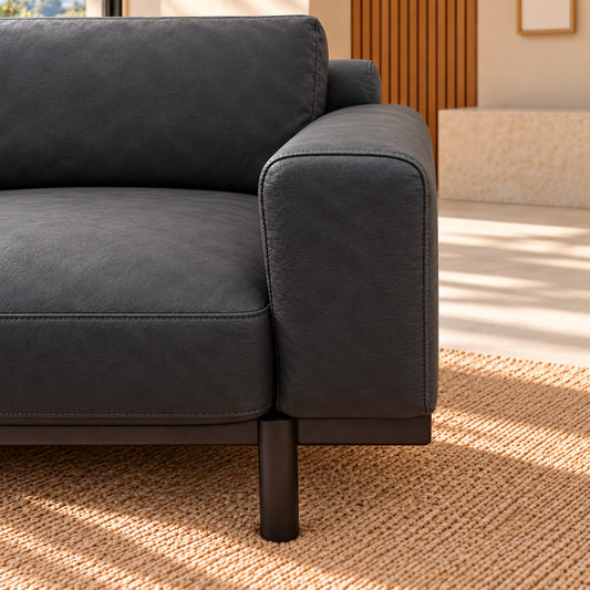 Sempre black leather armchair, seat cushion, arm and timber leg detail