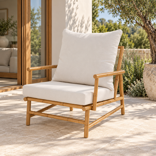 Miami aluminium outdoor armchair, angled view with light cushions on a patio