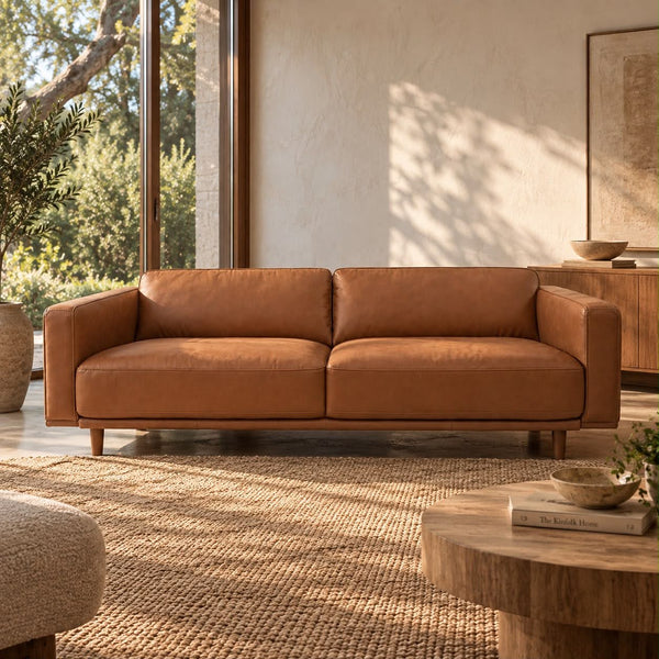 Hugo three-seater tan leather sofa, front view in a living room